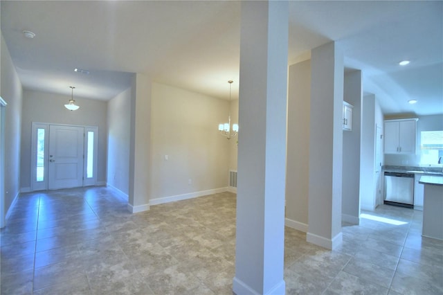 foyer entrance with a notable chandelier and plenty of natural light