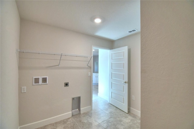 clothes washing area with washer hookup, light tile patterned floors, and electric dryer hookup