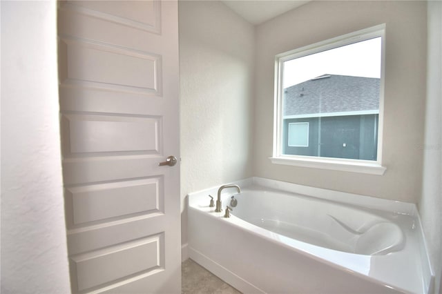 bathroom featuring a tub to relax in and tile patterned floors