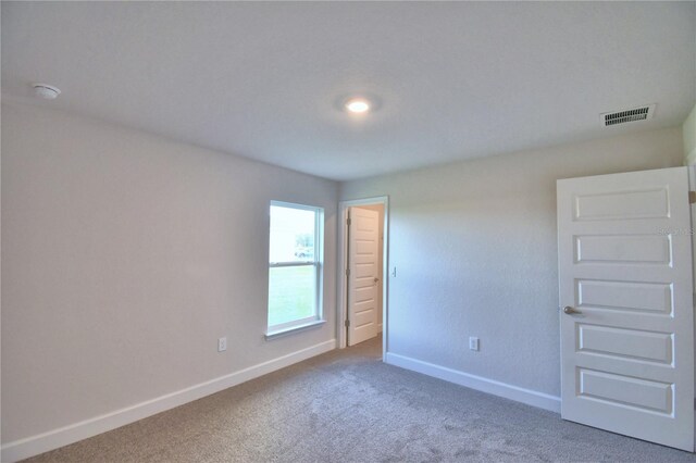 unfurnished room with carpet flooring