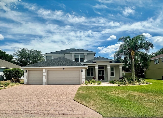 view of front of home featuring a garage and a front yard