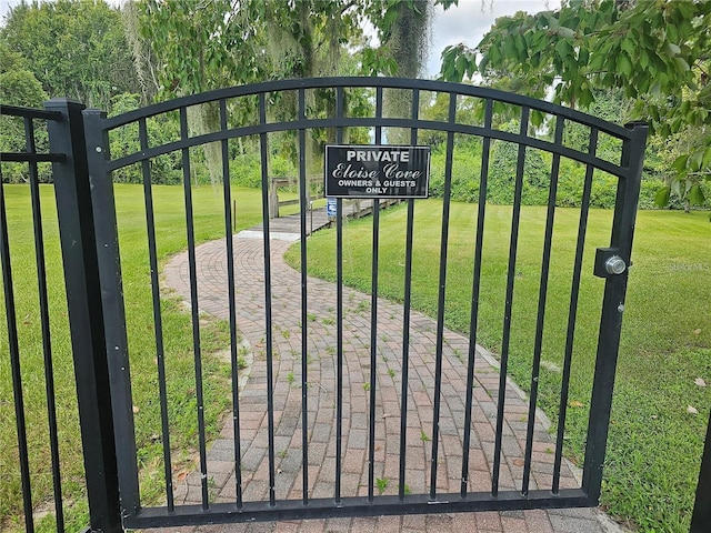 view of gate featuring a lawn