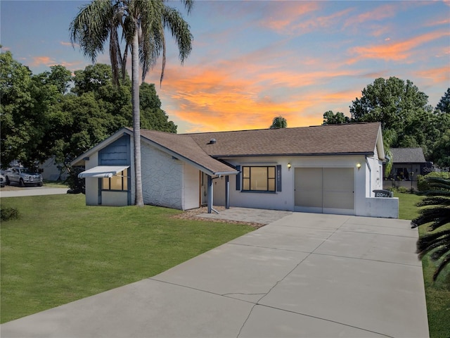 view of front of home with a lawn and a garage