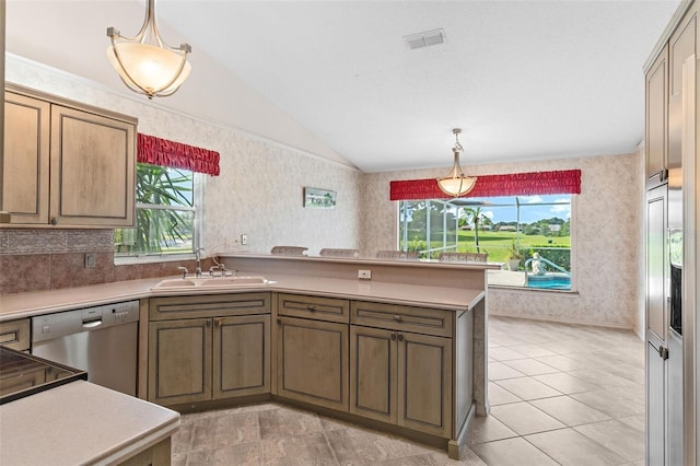 kitchen featuring dishwasher, vaulted ceiling, a wealth of natural light, and hanging light fixtures