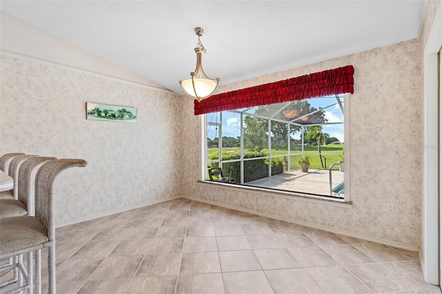 unfurnished dining area with lofted ceiling