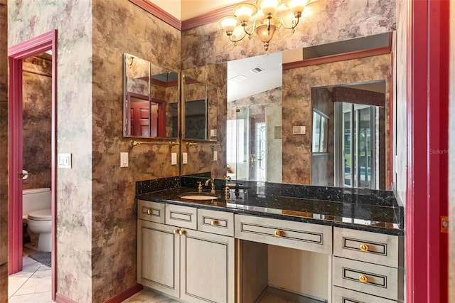 bathroom featuring tile patterned floors, vanity, toilet, and crown molding