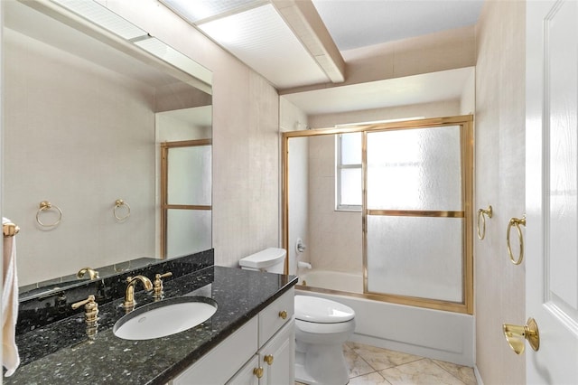 full bathroom featuring tile patterned floors, vanity, toilet, and enclosed tub / shower combo