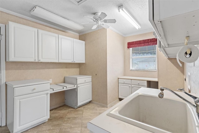 laundry room with ceiling fan, sink, a textured ceiling, and ornamental molding