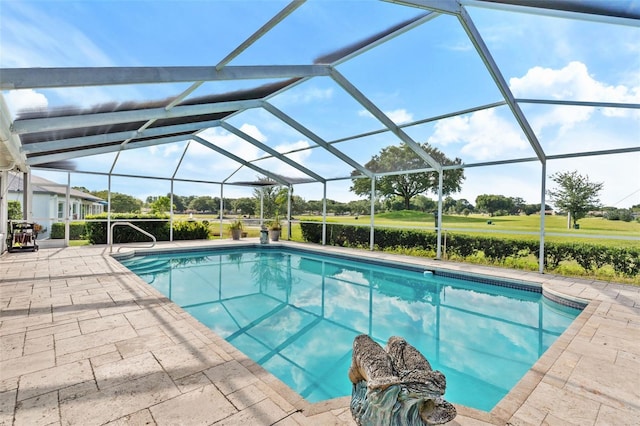 view of swimming pool featuring glass enclosure and a patio area