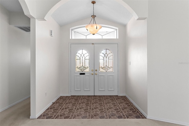 foyer entrance featuring vaulted ceiling and french doors