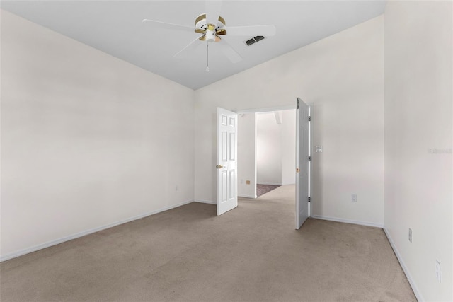 carpeted spare room with vaulted ceiling and ceiling fan