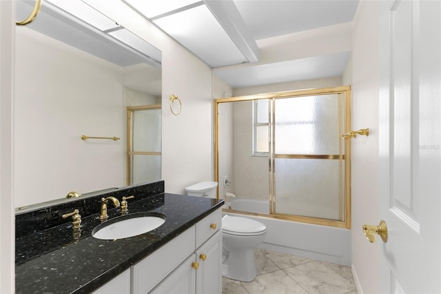 full bathroom with vanity, bath / shower combo with glass door, and toilet