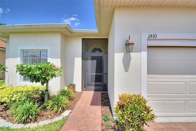 doorway to property with a garage