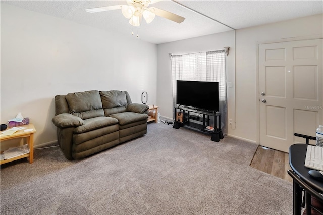 carpeted living room with a textured ceiling and ceiling fan