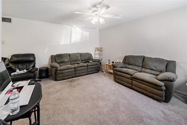 living room with ceiling fan, a textured ceiling, and carpet flooring