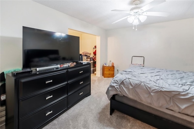 bedroom with ceiling fan and light colored carpet