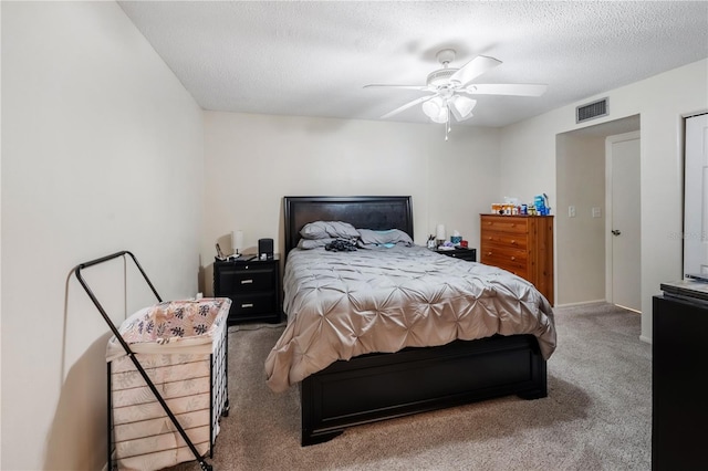 carpeted bedroom with a textured ceiling and ceiling fan