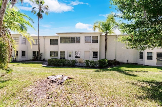 rear view of property with a lawn