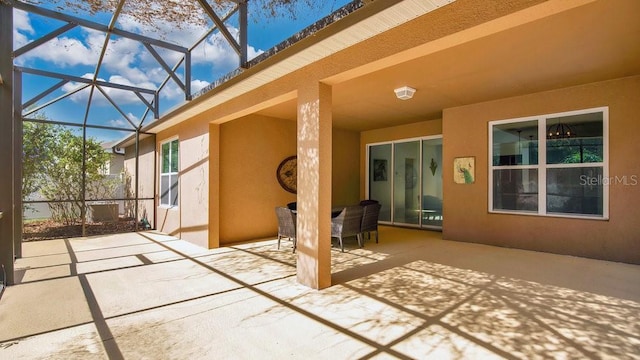 view of patio / terrace featuring glass enclosure