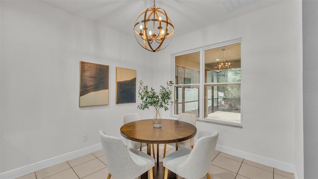 dining space featuring light tile patterned flooring and a chandelier