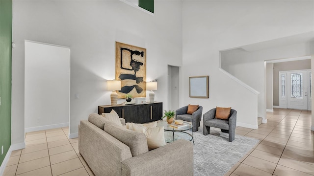 tiled living room featuring a towering ceiling