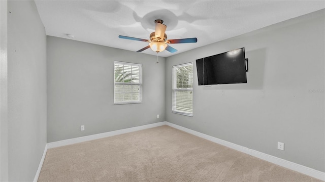 unfurnished room featuring light carpet and ceiling fan