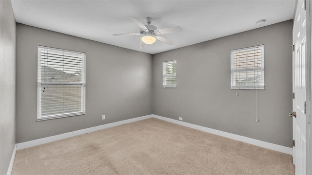 spare room featuring ceiling fan and light carpet