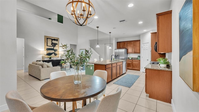 dining room featuring light tile patterned flooring, an inviting chandelier, and sink