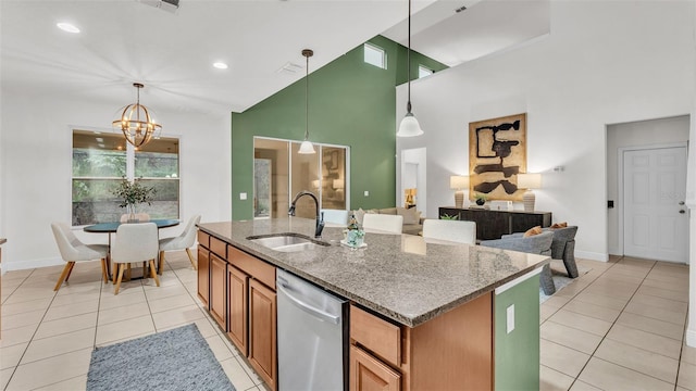 kitchen featuring dishwasher, pendant lighting, stone countertops, and sink