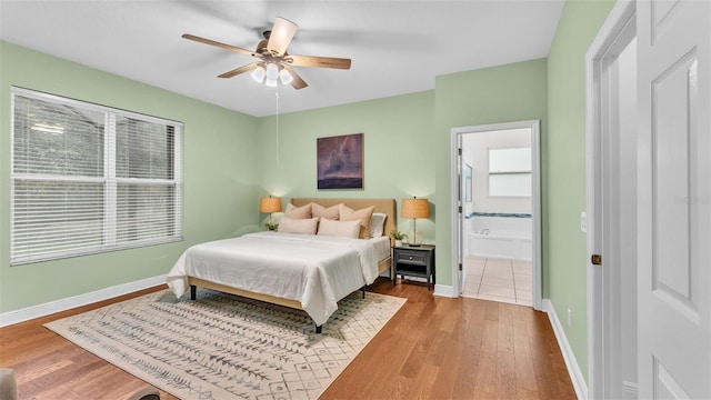 bedroom featuring hardwood / wood-style flooring, ceiling fan, and ensuite bathroom