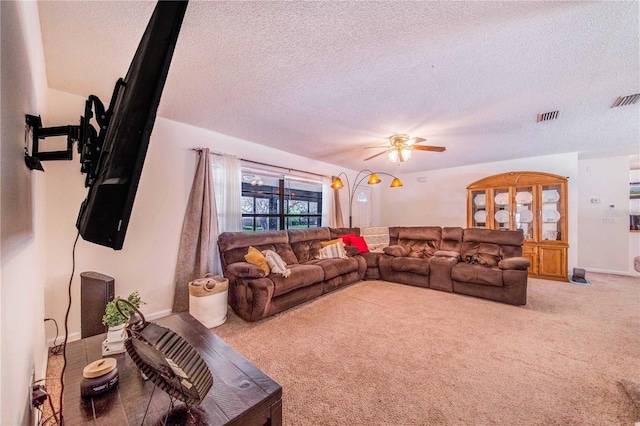 carpeted living room with a textured ceiling and ceiling fan