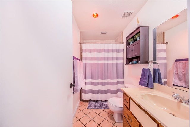 bathroom featuring tile patterned floors, vanity, curtained shower, and toilet