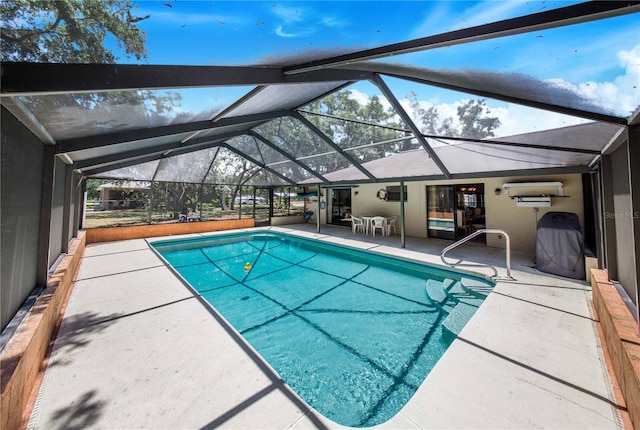 view of pool featuring a wall mounted air conditioner, a patio area, and a lanai