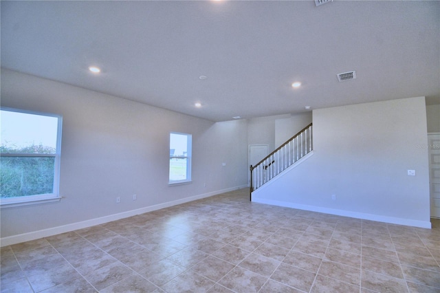 empty room featuring light tile patterned floors and a wealth of natural light