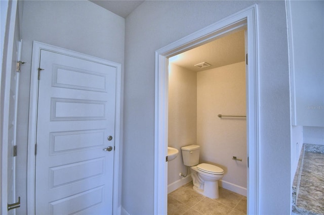 bathroom with tile patterned floors and toilet