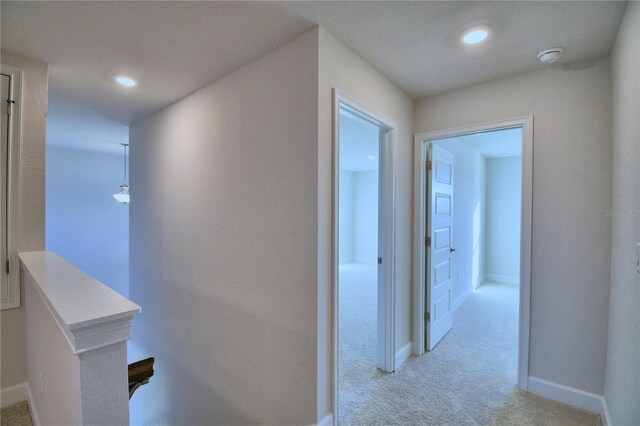 corridor with light colored carpet