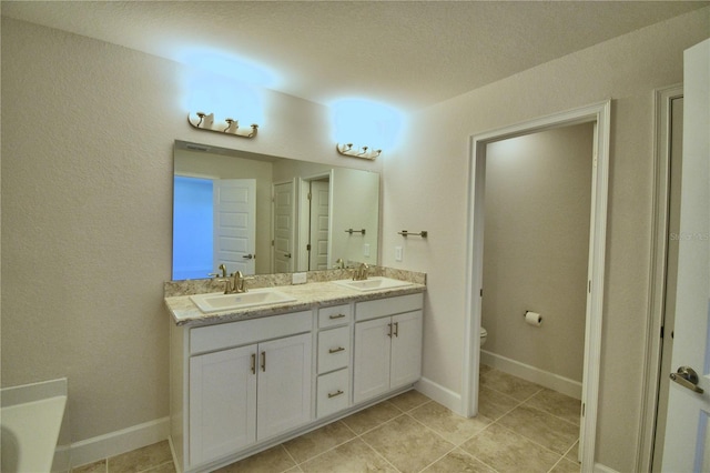 bathroom featuring vanity, a bathtub, and toilet