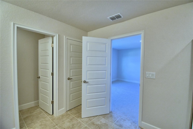 hall with light colored carpet