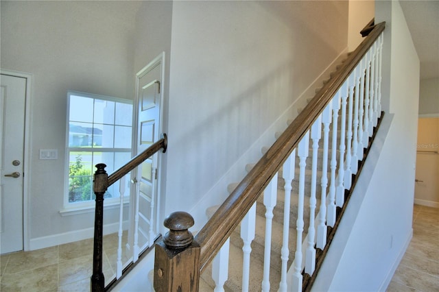 staircase featuring tile patterned floors