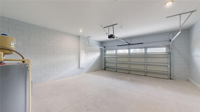 garage with a garage door opener and water heater