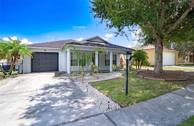 single story home featuring a garage and a front yard