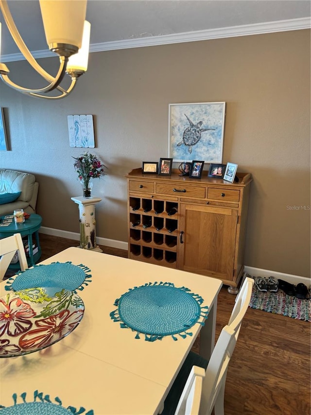 dining area featuring ornamental molding and a chandelier