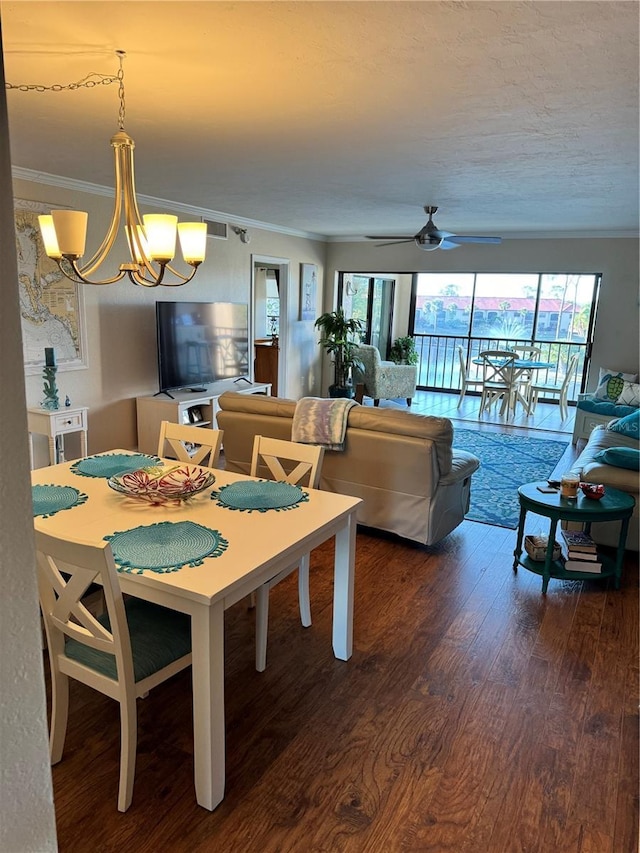 dining area featuring hardwood / wood-style floors, plenty of natural light, ornamental molding, and ceiling fan with notable chandelier