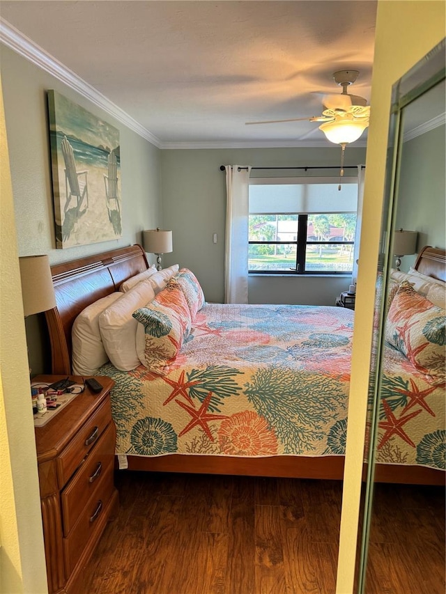 bedroom featuring ceiling fan, dark hardwood / wood-style flooring, and ornamental molding