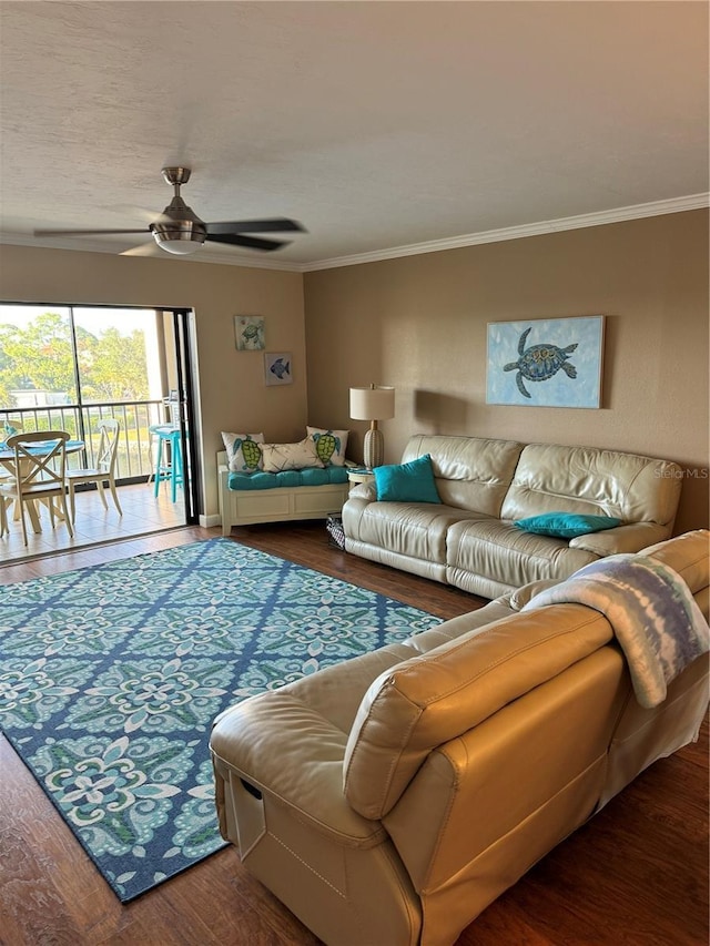 living room featuring hardwood / wood-style flooring, ceiling fan, and crown molding