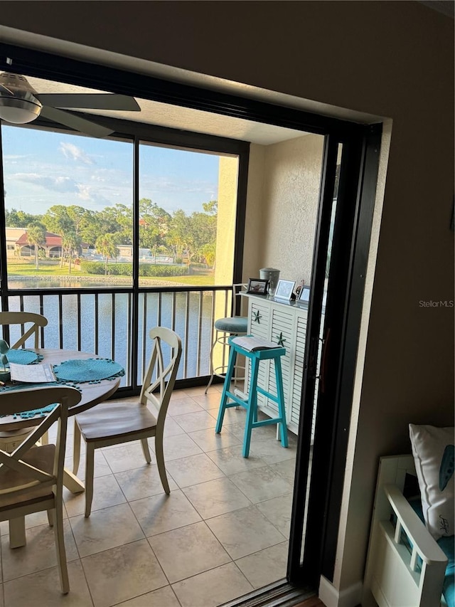 sunroom featuring a water view