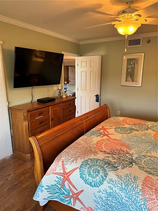 bedroom featuring hardwood / wood-style flooring, ceiling fan, and ornamental molding