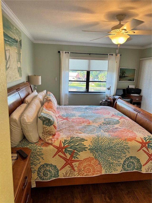 bedroom featuring ceiling fan, crown molding, and hardwood / wood-style flooring