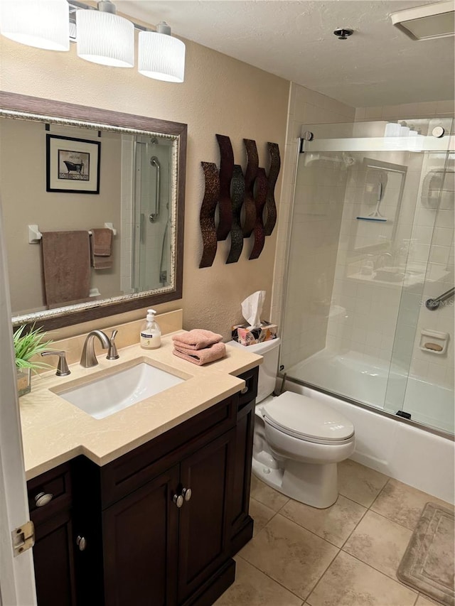 full bathroom featuring tile patterned flooring, vanity, toilet, and enclosed tub / shower combo