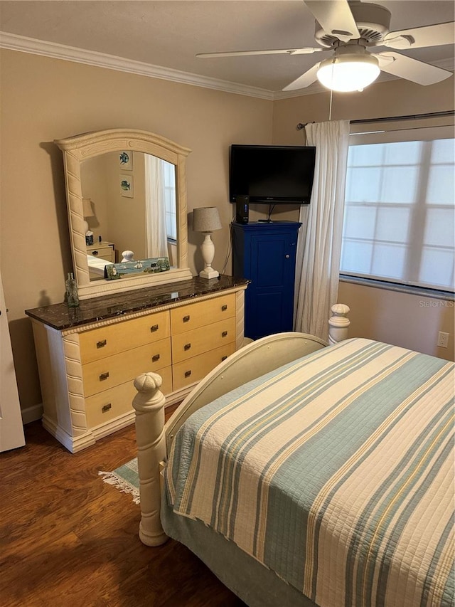 bedroom with crown molding, ceiling fan, and dark wood-type flooring